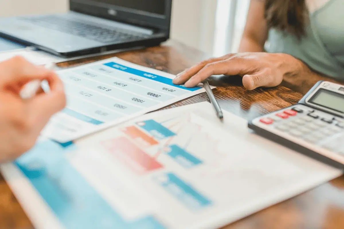 Business people reviewing financial charts and data.