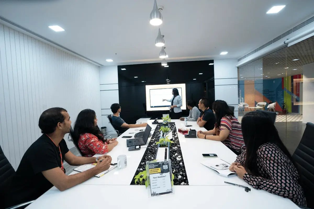 Team attending a business presentation in a modern conference room.
