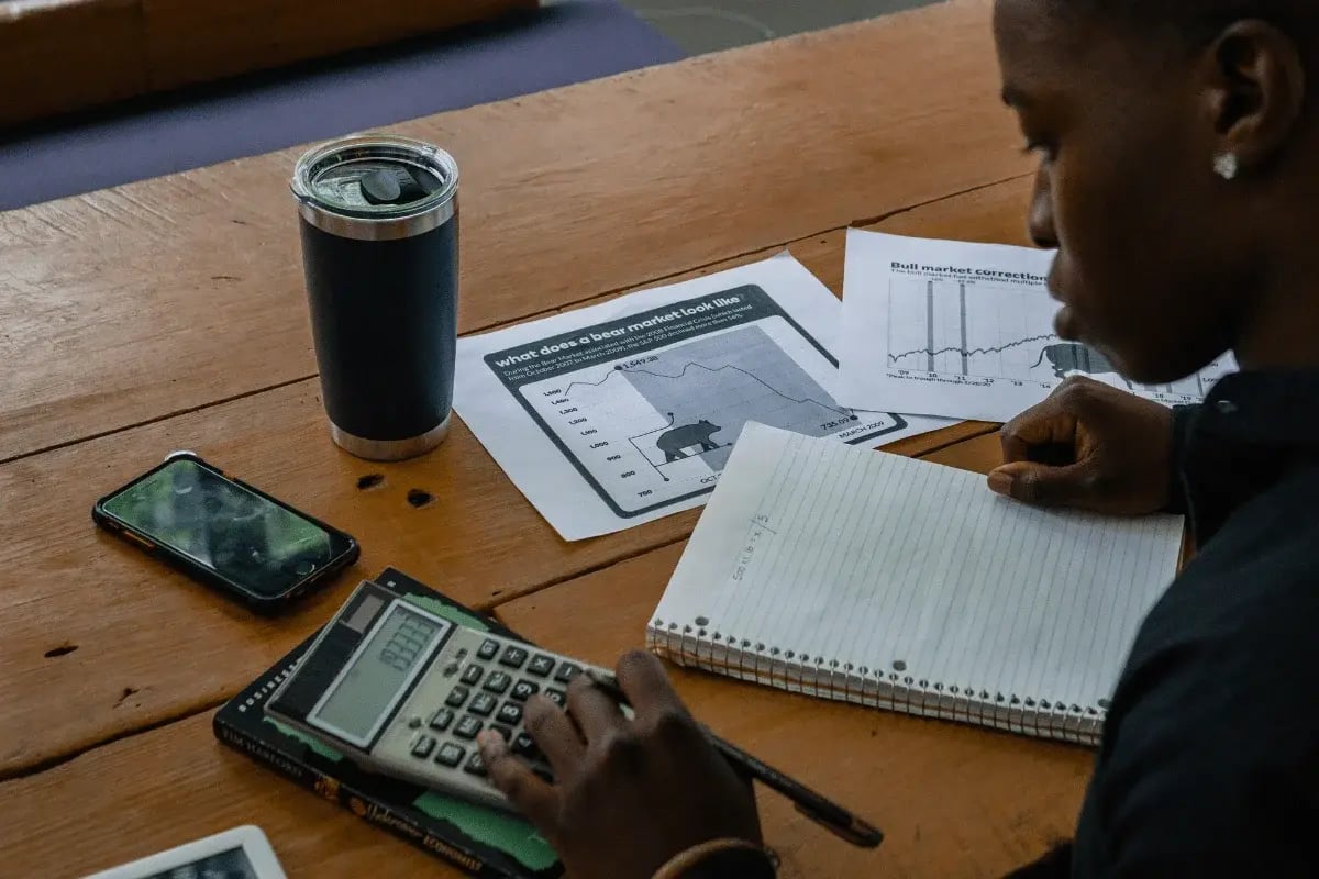 Business professional reviewing detailed financial charts on a laptop screen.